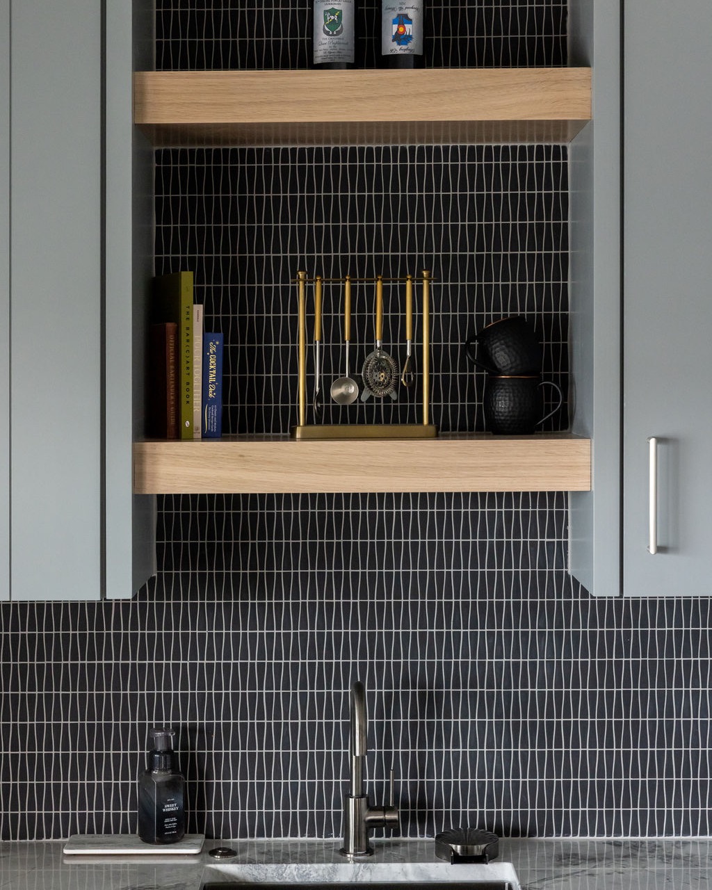 Open kitchen shelving with wood accents, modern tile backsplash, and minimalist styling in a contemporary Omaha home